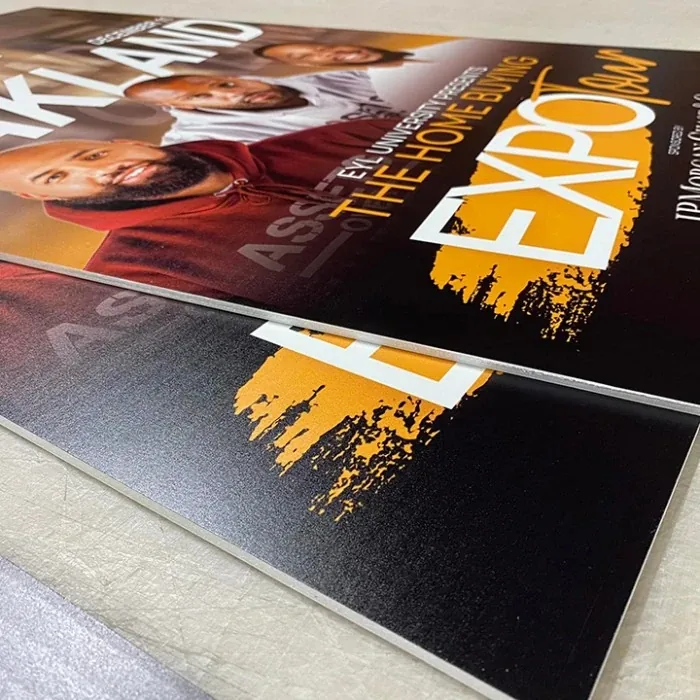 Printed foam board sign photographed at an angle on a floor