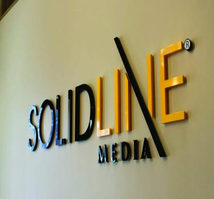 Cut-out dimensional lettering mounted on an interior wall, lit from the side