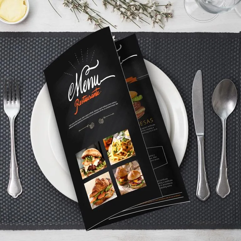 Folded restaurant menu laid on a place setting with cutlery