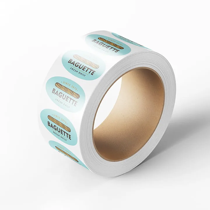 Roll of printed adhesive labels on a white surface